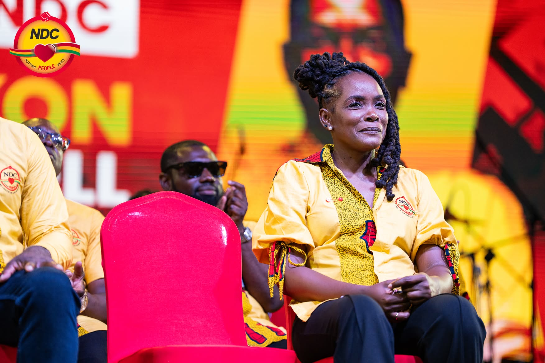 Caris DeGannes seated on stage at a campaign event