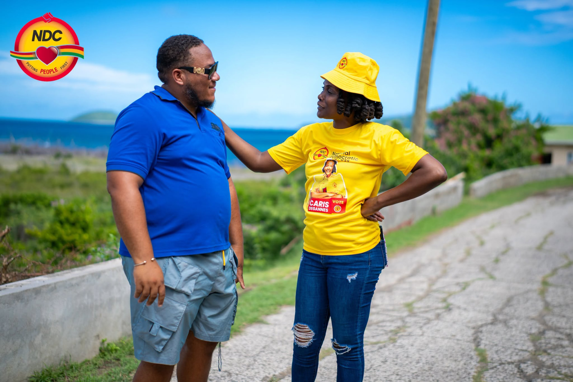 Caris DeGannes talking with a resident on a coastal road